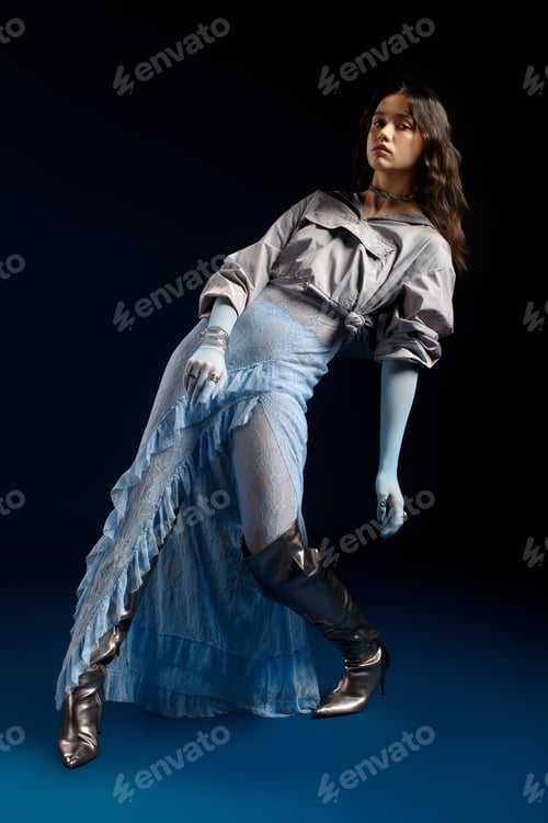 Preview: Stylish young woman in striking outfit showcasing modern fashion in studio