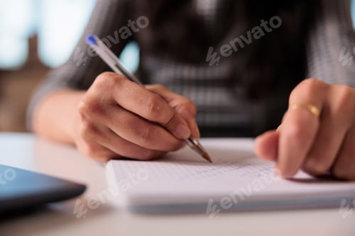 Preview: Employee writing information on notebook