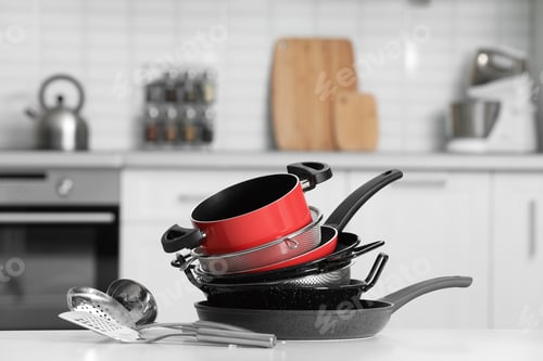 Preview: Set of clean cookware and utensils on table in kitchen