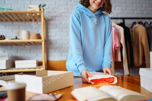 Preview: Close-up of preparing a parcel on the table. Woman online store, small business owner, entrepreneur.