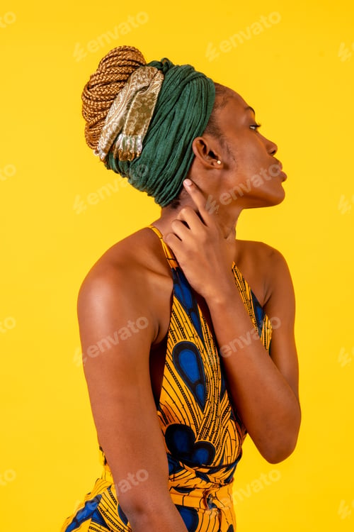 Preview: A person woman of black ethnicity with traditional costume on yellow background, profile model