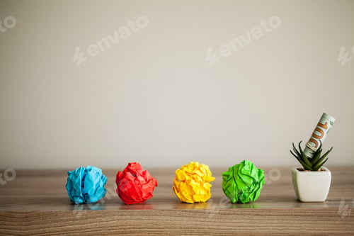 Preview: Great idea concept. Crumpled colorful paper on wooden table. Copy space