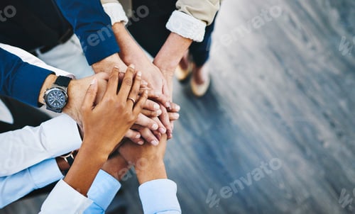 Preview: Shot of a group of unrecognisable businesspeople joining their hands together in unity in an office