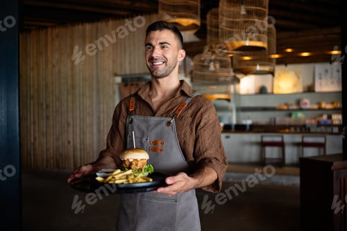 Preview: Waiter serves a fresh burger and fries in stylish restaurant, capturing the essence of great service