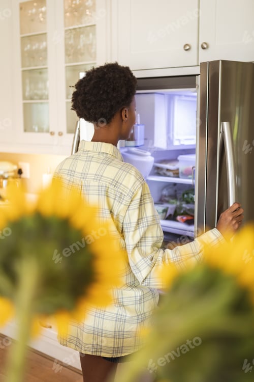 Preview: Woman opening the fridge
