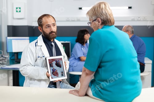 Preview: Medical specialist explaining cardiology figure to elder patient