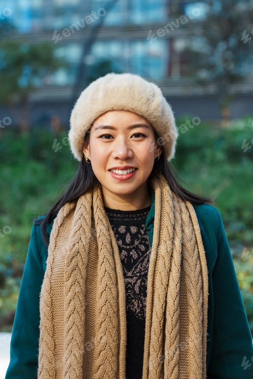Preview: Asian business woman looking at camera and smile while standing outdoors on the street at financial