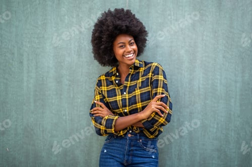 Preview: Smiling young african american woman on green background
