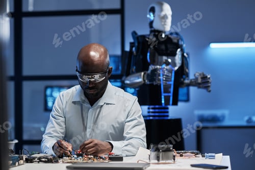 Preview: Engineer working with motherboard of robot
