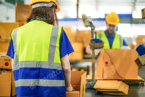 Preview: Warehouse worker folding paper box for packing the items in a large warehouse