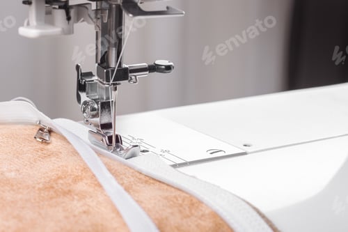 Preview: Modern Sewing Machine Special Presser Foot With Beige Fabric And Zipper, Closeup