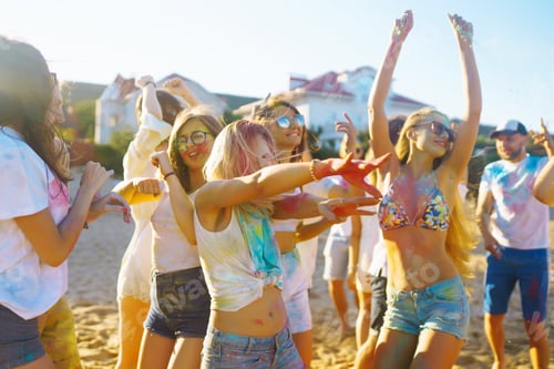 Preview: Teenagers Friends have fun at holi festival. Beach Party. Celebrating traditional indian holiday.