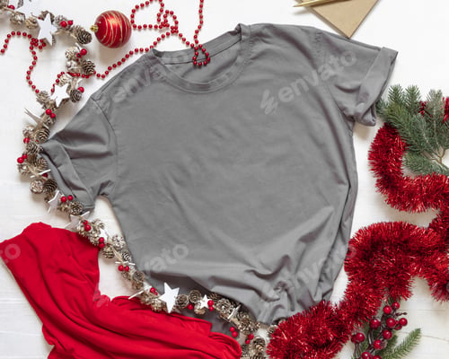 Preview: Blank gray unisex t-shirt near golden and red Christmas decor on white top view, Mockup
