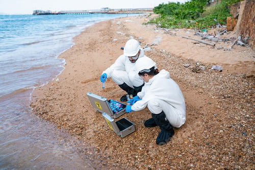 Preview: Scientists biologists taking water samples from waste water from industrial.