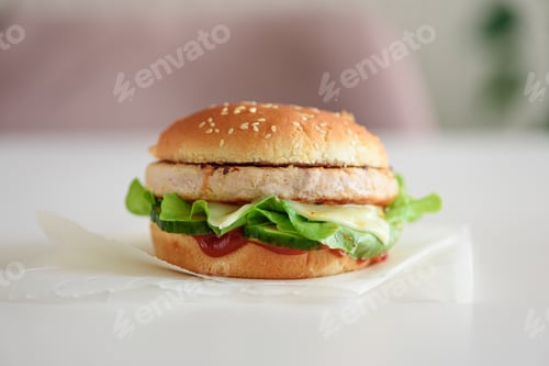 Preview: Homemade cheeseburger on white table