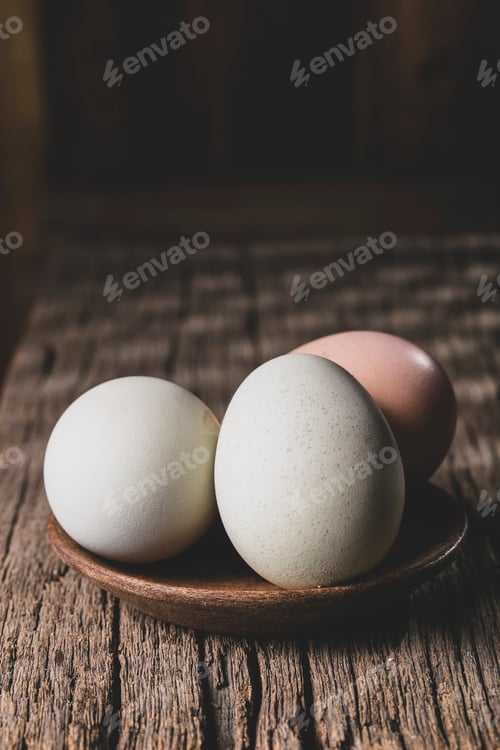 Preview: Hen eggs on rustic wooden background
