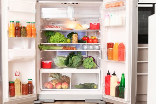 Preview: Open refrigerator filled with different food in kitchen