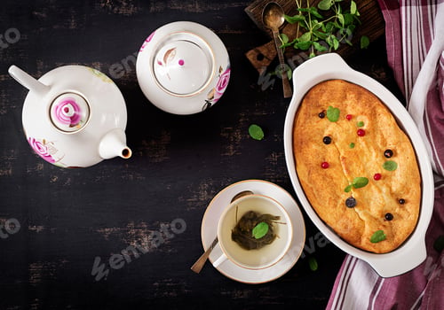 Preview: Breakfast. Appetizing cottage cheese casserole on dark table. Top view