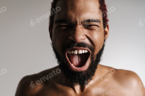Preview: Black shirtless excited man screaming and looking at camera