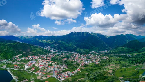 Preview: Bulgarian town Smolyan with lake, vegetation and clouds. Rhodope Mountains. Panorama, top view