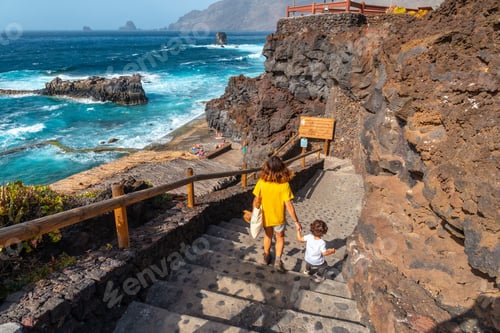 Preview: A mother with her son going down into the La Maceta rock pool on the island of El Hierro