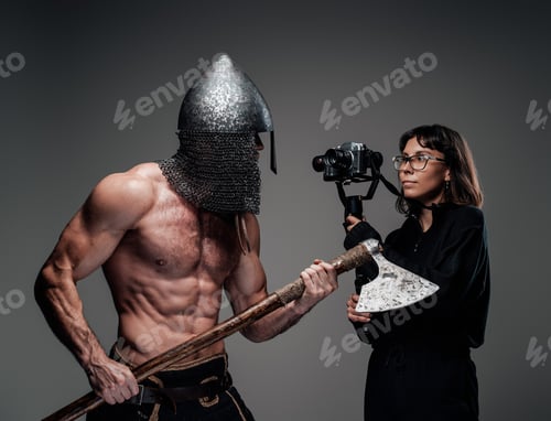 Preview: Bearded shirtless guy with helmet and axe with photographer
