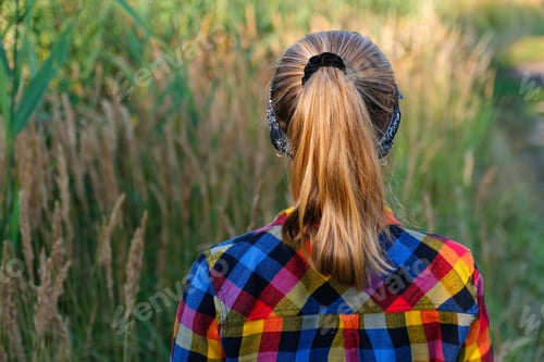 Preview: Woman Walks Through a Field of Tall Grass