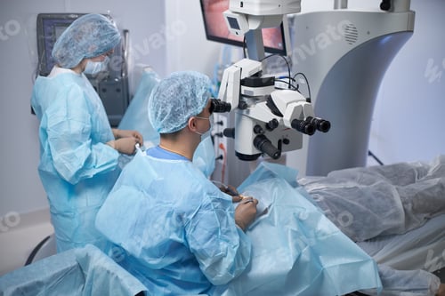 Preview: Middle Aged Male Surgeon Performing Operation in Modern Operating Room