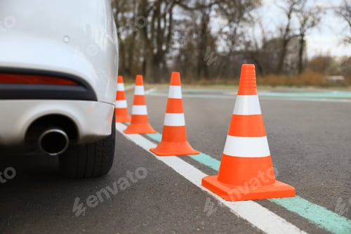 Preview: Modern car on test track with traffic cones, closeup. Driving school