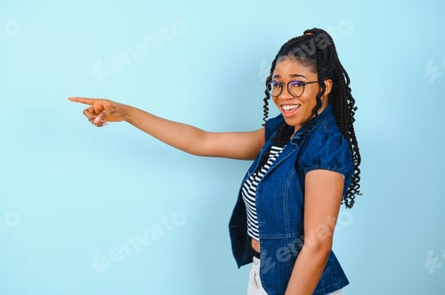 Preview: Check this offer. Positive black lady pointing fingers at free space looking and smiling