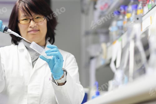 Preview: Scientist pipetting liquid in lab