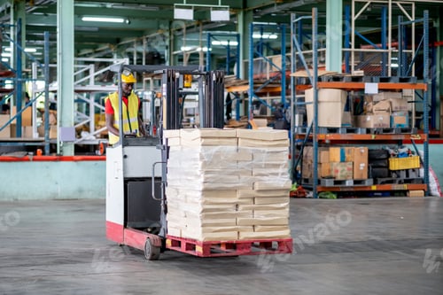Preview: African American factory man or warehouse worker stand on forklift during work