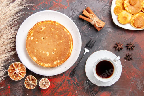 Vista previa: Breakfast time with pancakes a cup of tea lemons and cinnamon lime