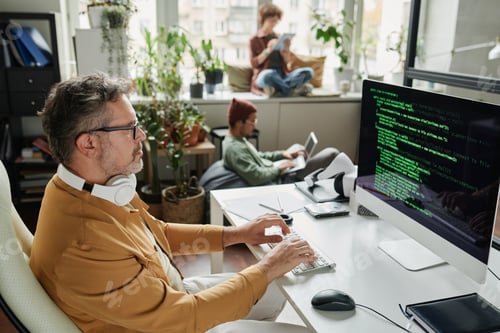 Preview: Confident mature businessman looking at coded data