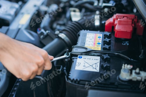 Preview: A man is maintenance on his car, checking and change the battery. Car maintenance concept.