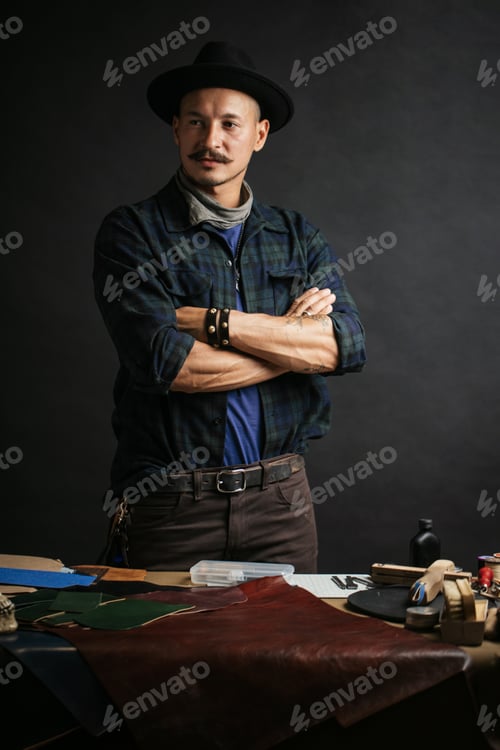 Preview: Professional shoemaker in his workshop making and repairing custom made shoes