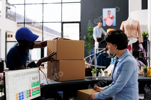 Preview: Courier looking at cardbord boxes