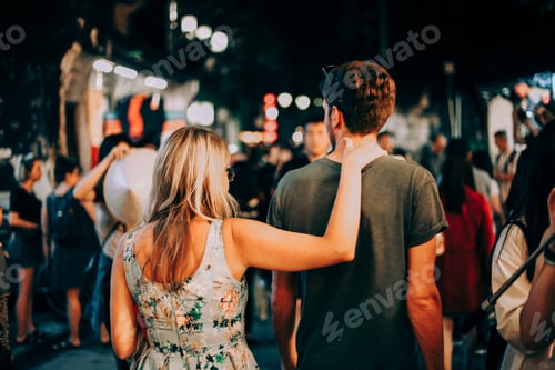 Preview: Couple Embrace During a Nighttime Street Market Visit