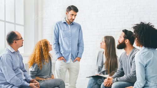 Preview: Young man talking about his problems during group therapy