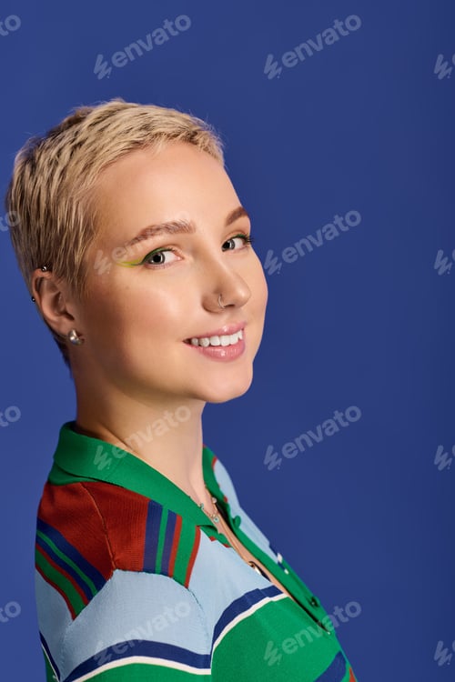 Preview: Young beautiful woman exudes confidence in vibrant fashion against a solid blue background