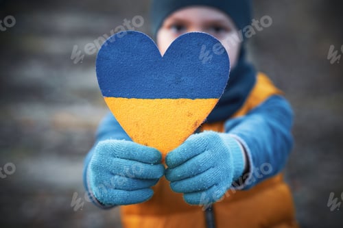 Preview: Picture of a child with a lot of love and peaceful message holding heart