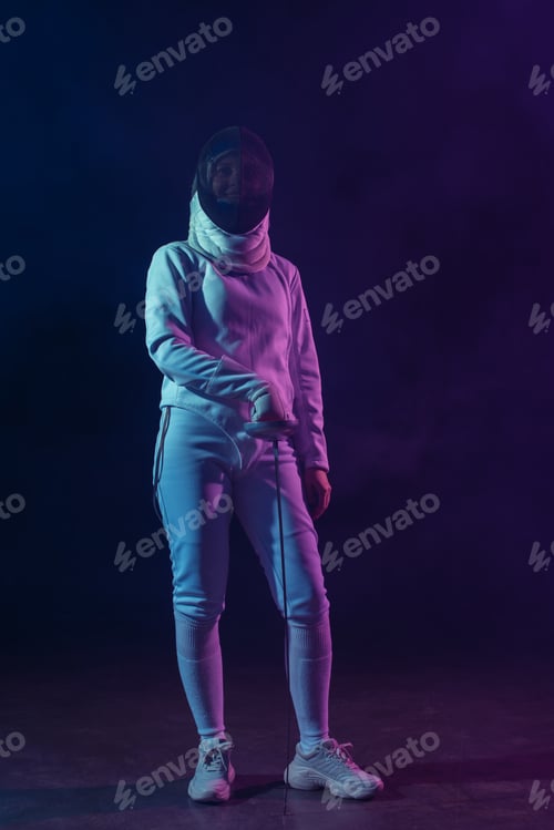 Preview: Swordswoman in fencing suit, mask and glove holding rapier on black background