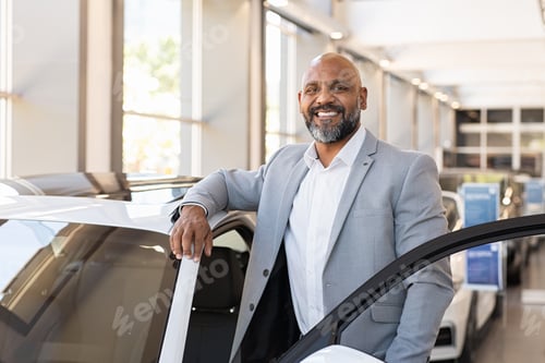 Preview: Happy mature black man at car dealership
