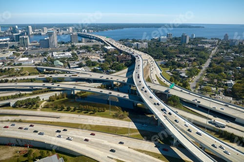 Preview: Aerial view of american freeway intersection with fast moving cars and trucks.