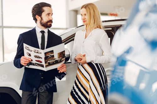 Preview: Stylish and elegant woman in a car salon