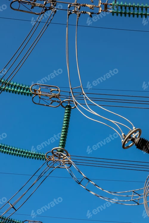 Preview: Vertical shot of electricity generation and distribution wires on background of the blue sky