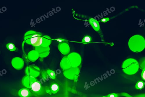 Preview: Bokeh of green garland lighting elements background