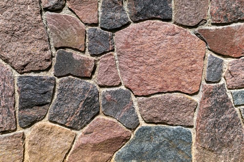 Preview: Closeup view of rustic stone wall showcasing various textured stones in natural colors and patterns