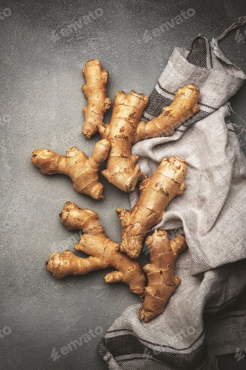 Preview: Fresh ginger root. Gray kitchen table background, top view