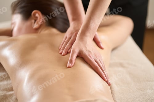 Preview: Woman receiving back massage at beauty salon